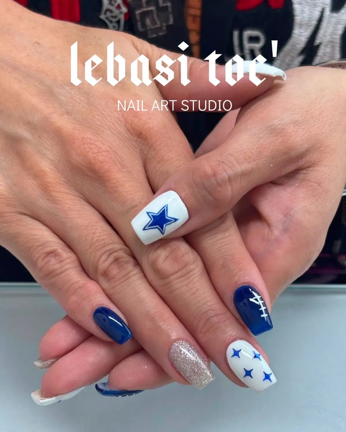 Dark blue, star accents, and football-lace detail