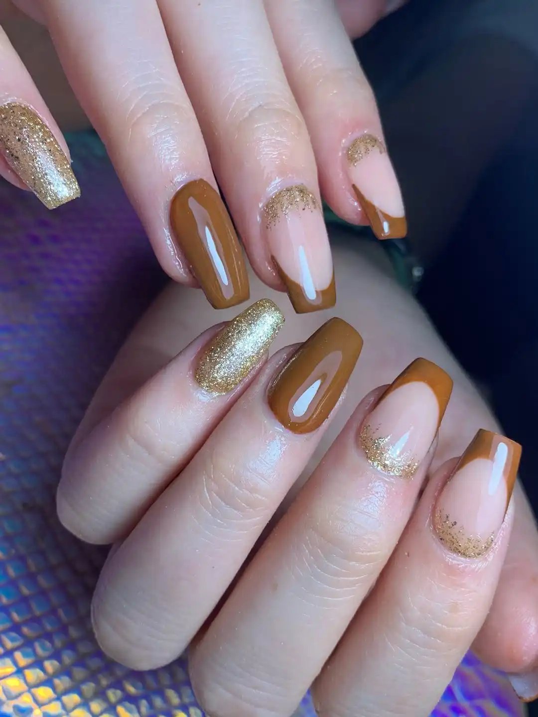 Medium-brown French tips with gold glitter gradients