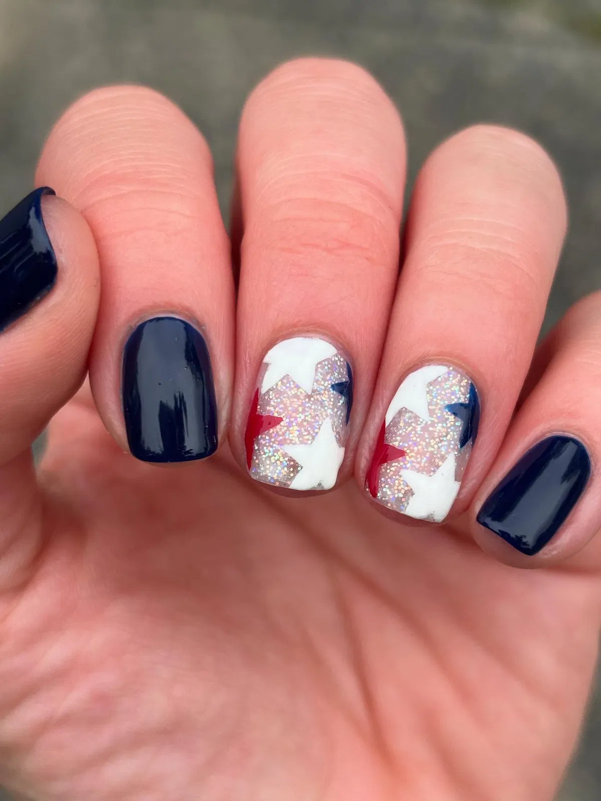 Navy solids with glitter star accent nails