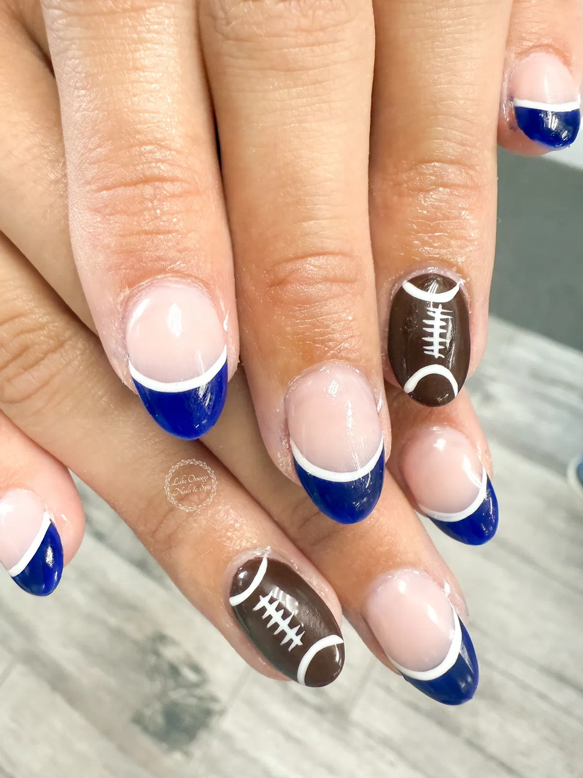 Blue French tips with brown football accents