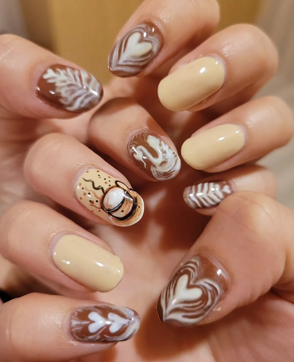 Cream solids with brown-white swirls, hearts, and a pumpkin accent