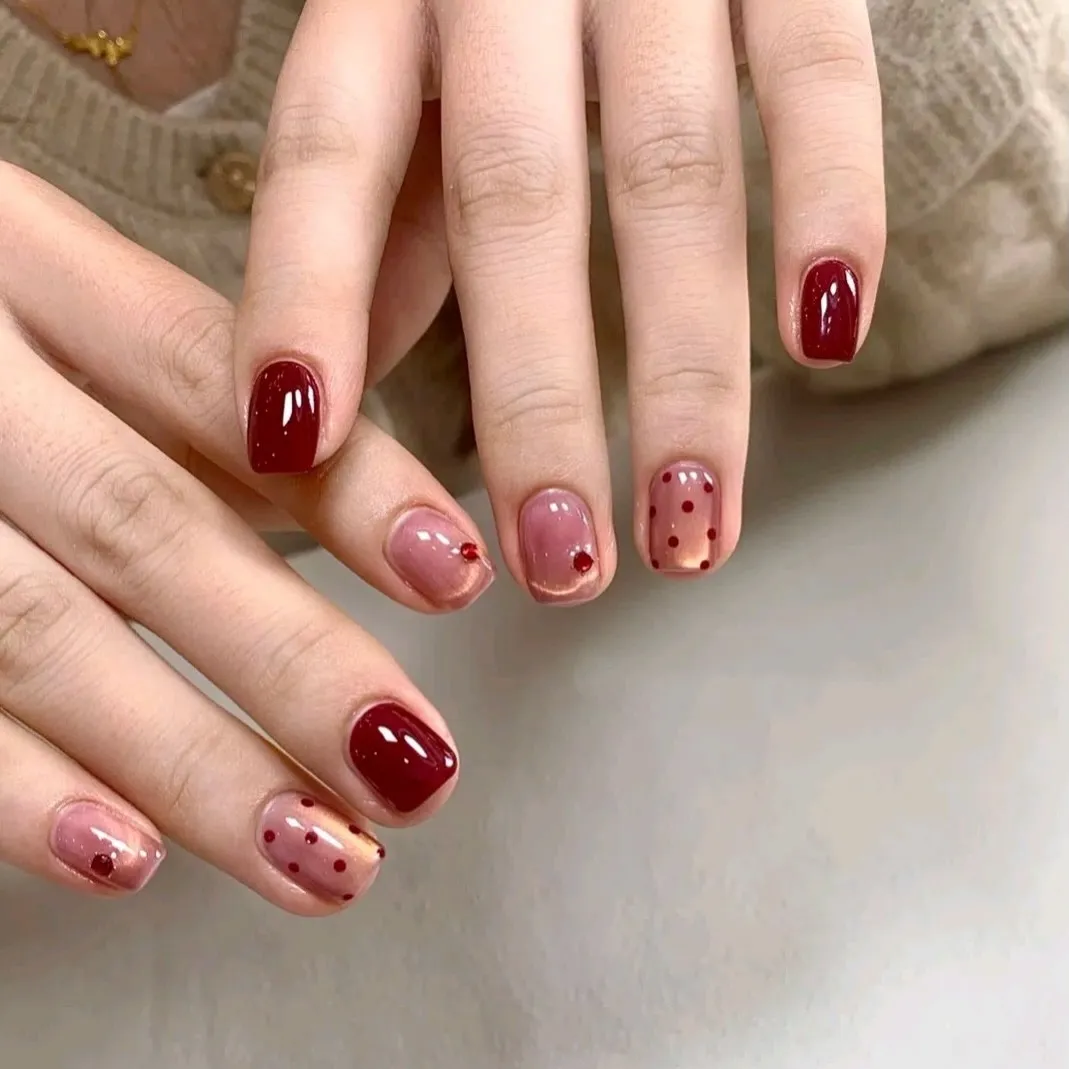 Deep red solids with translucent pink accents, red polka dots, and small gems