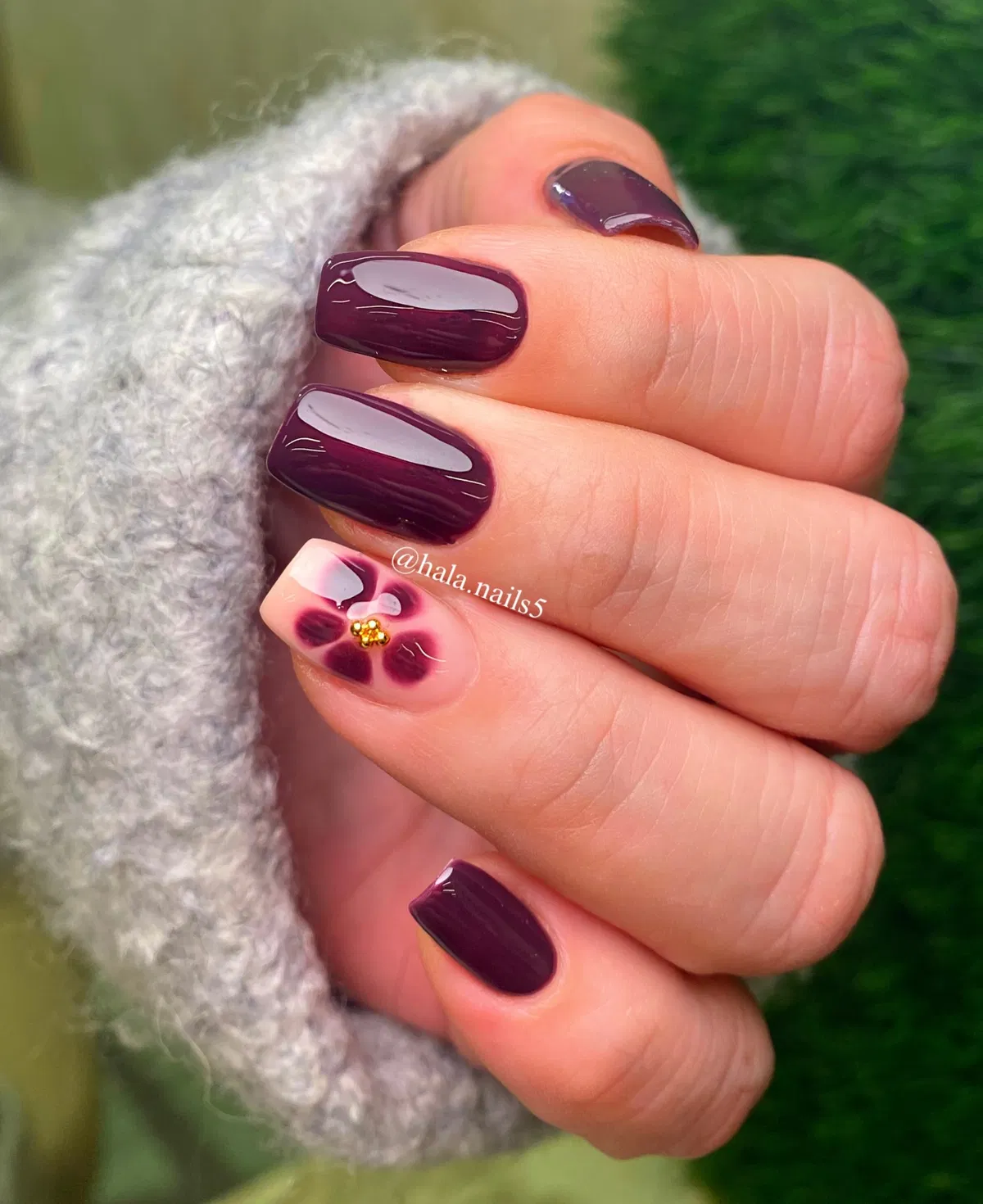 Square dark plum with a single floral accent