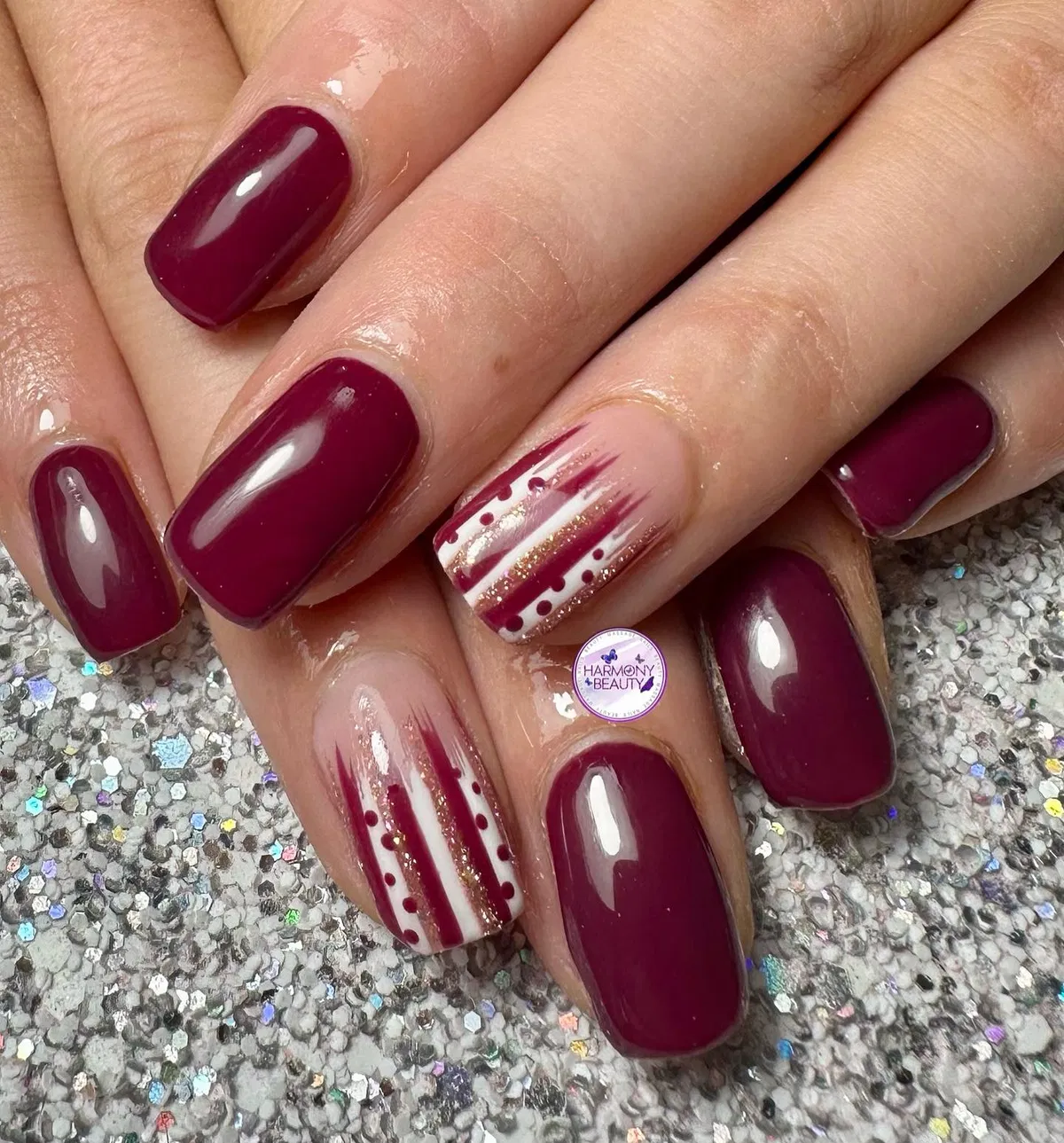 Deep plum with striped nude accent nails