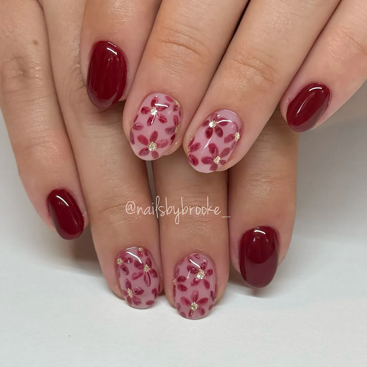 Deep plum-red with translucent leaf-pattern accents