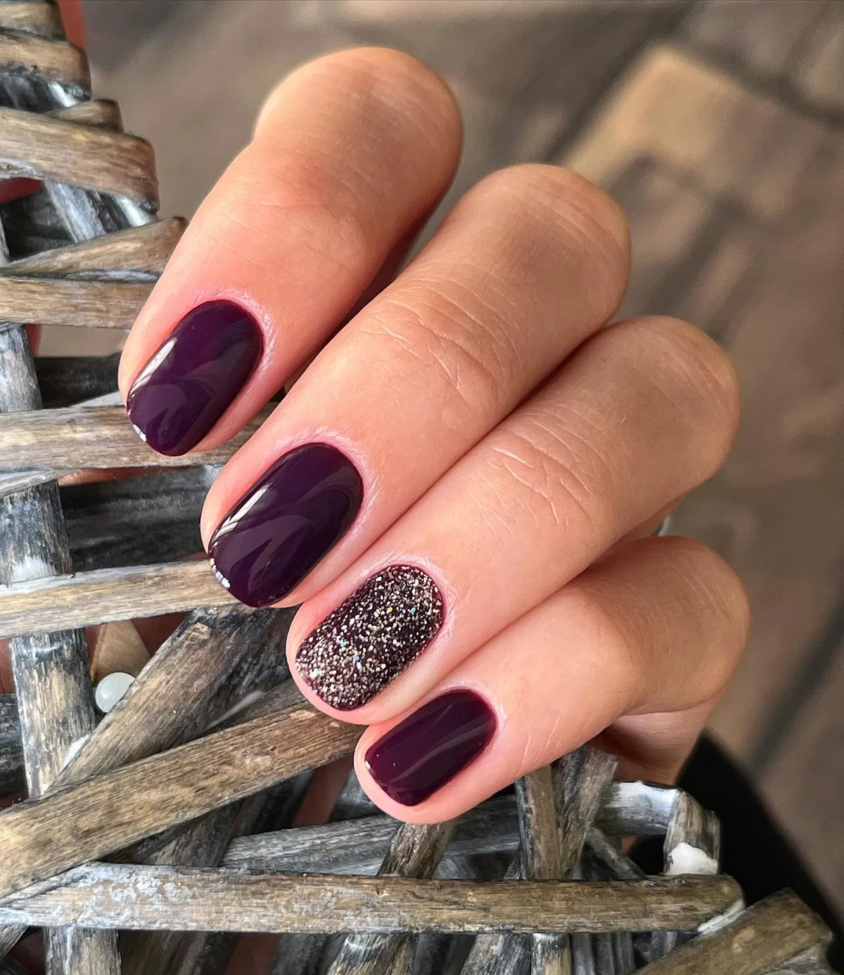 Glossy plum with a single glitter accent