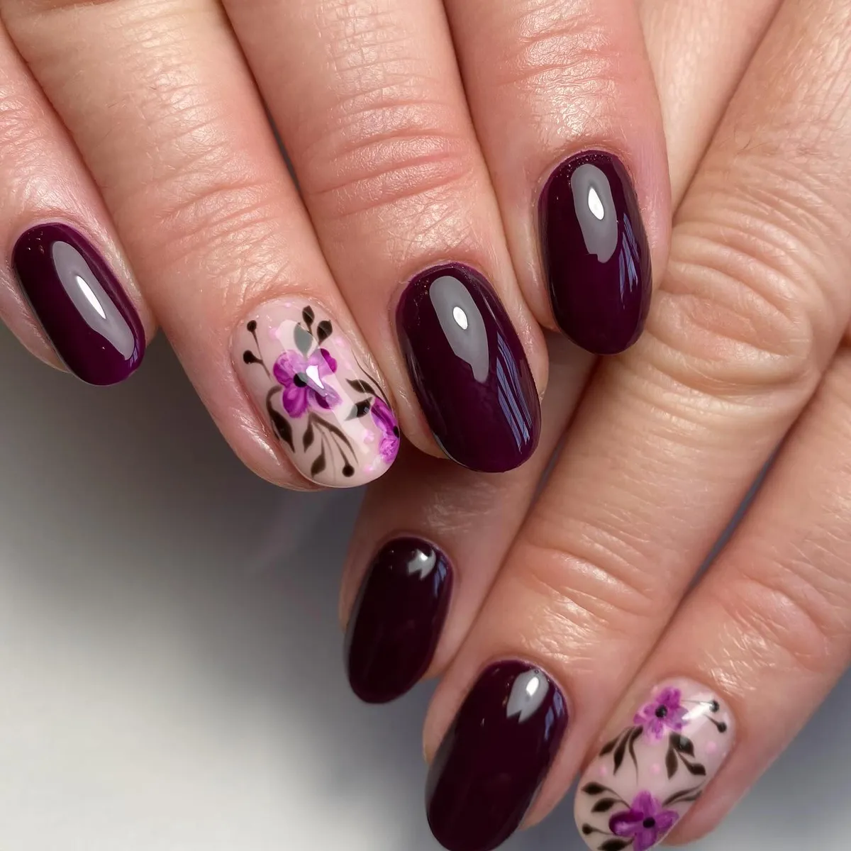 Deep plum with nude floral accent nails