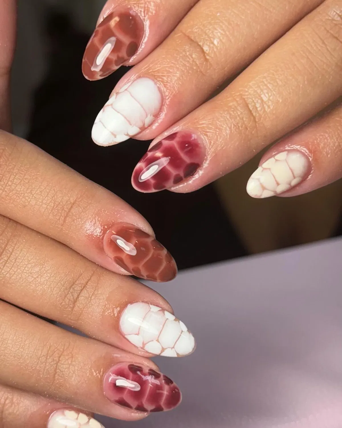 Cell-pattern nails in burgundy, brown, and white