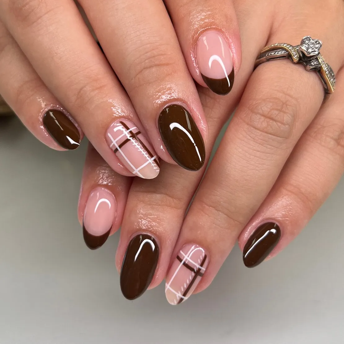 Brown French tips with pink-and-brown plaid accents