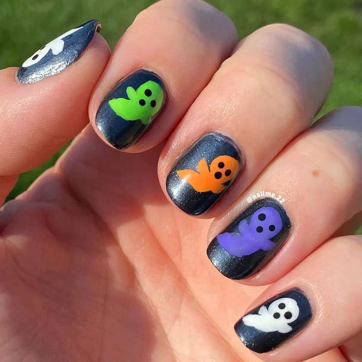 Colorful mini ghosts on dark base