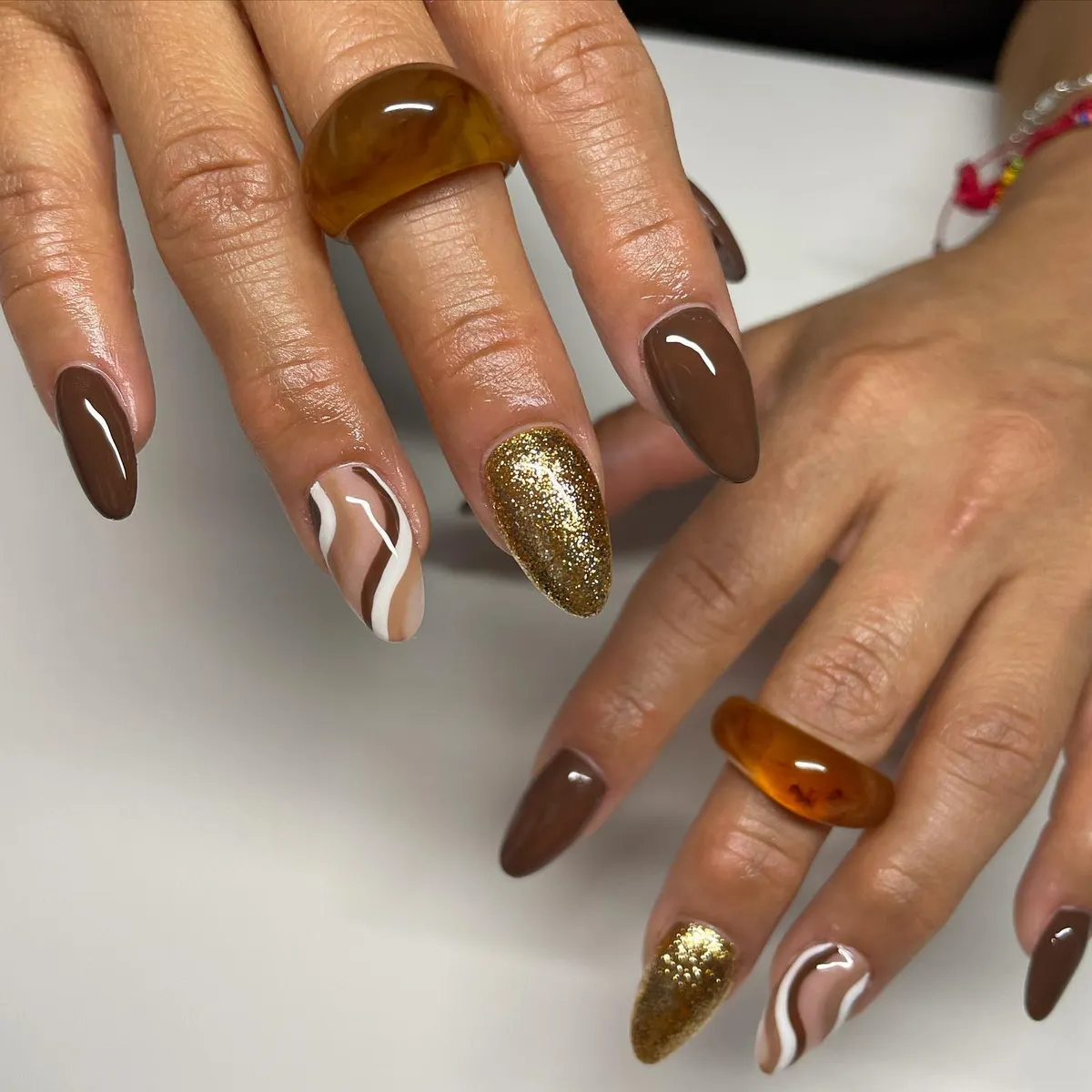 Dark brown solids with wavy nude accent and gold glitter