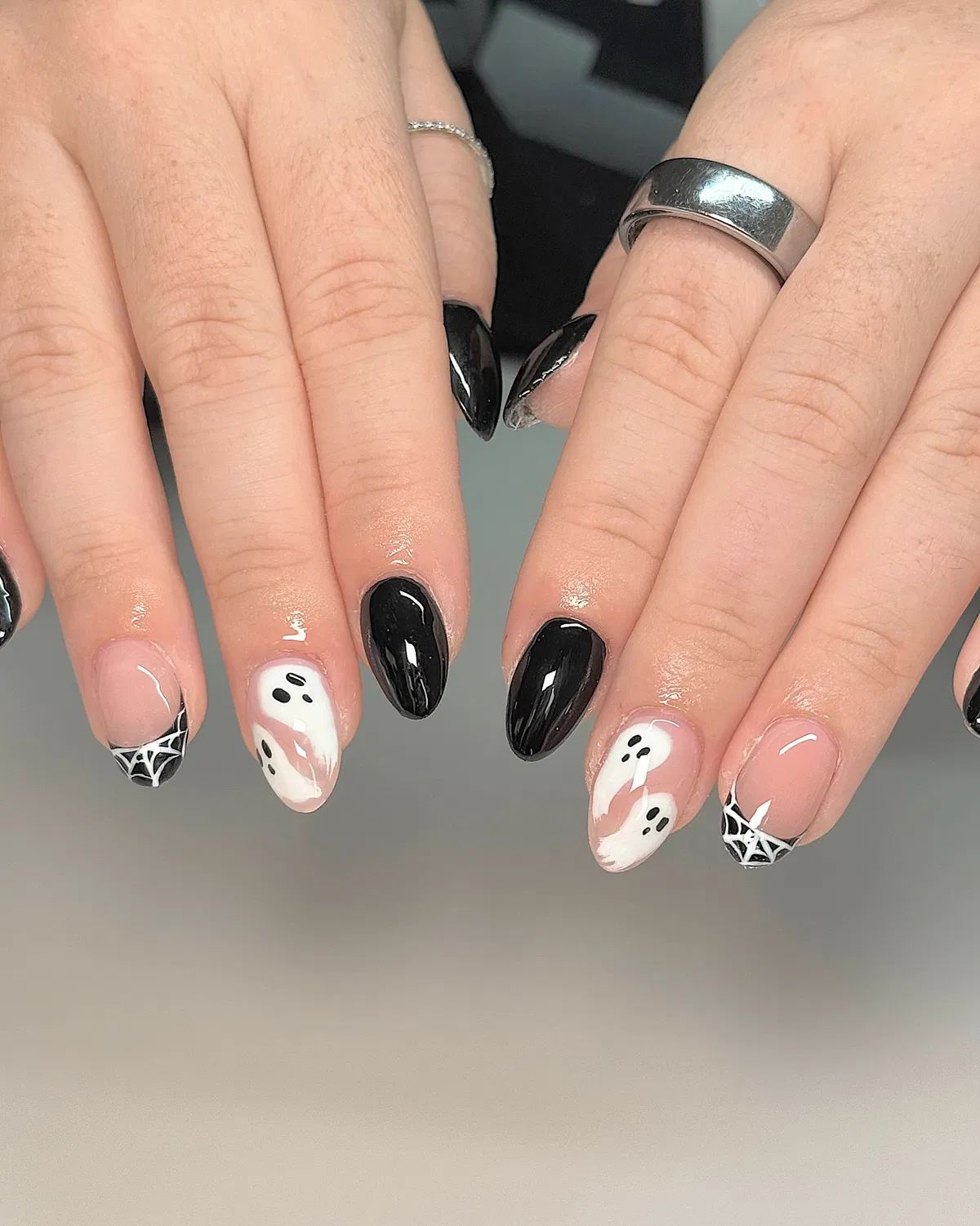 Black-and-white ghost and spiderweb accents on nude base