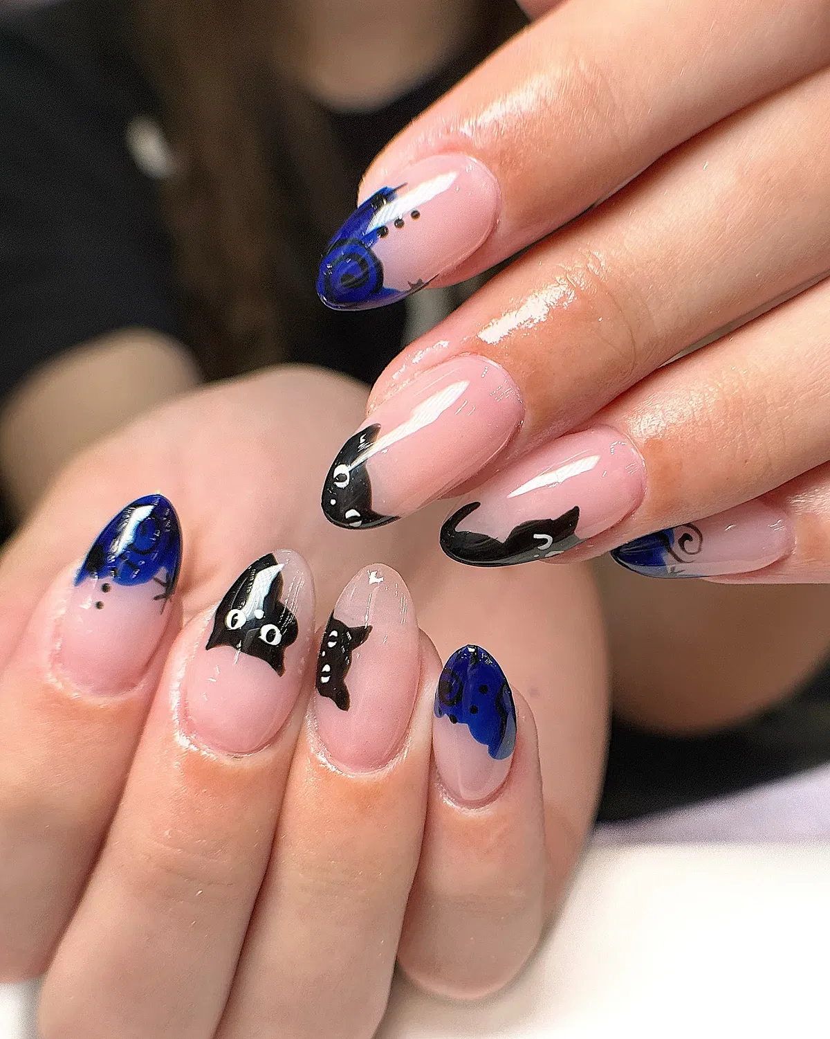 Nude base with black bat silhouettes and blue swirl tips