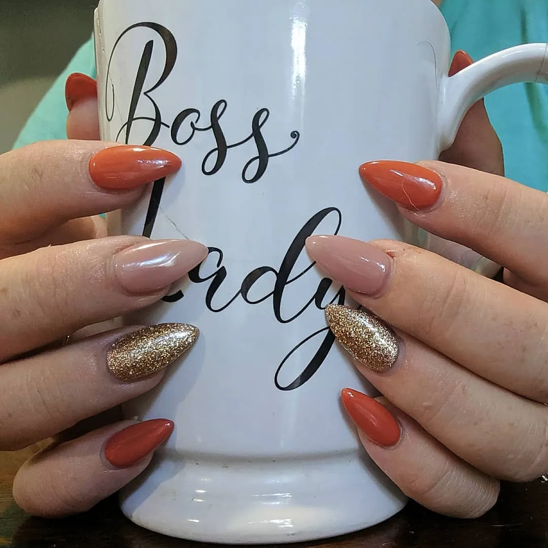 Burnt orange and nude with gold glitter accent nails
