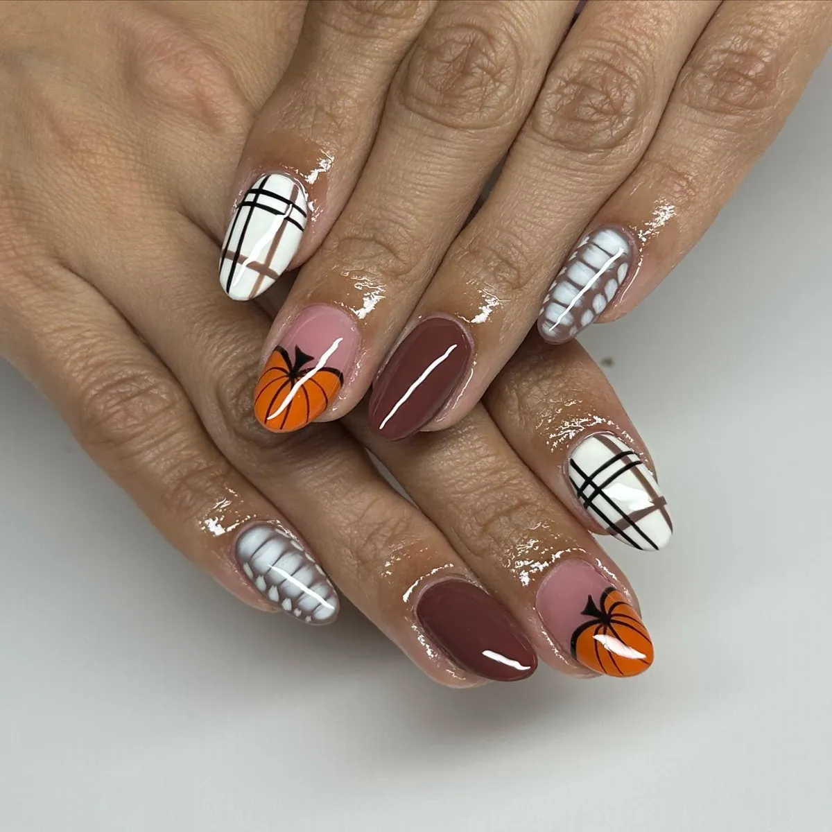 Plaid, pumpkin, and web accents in brown and orange