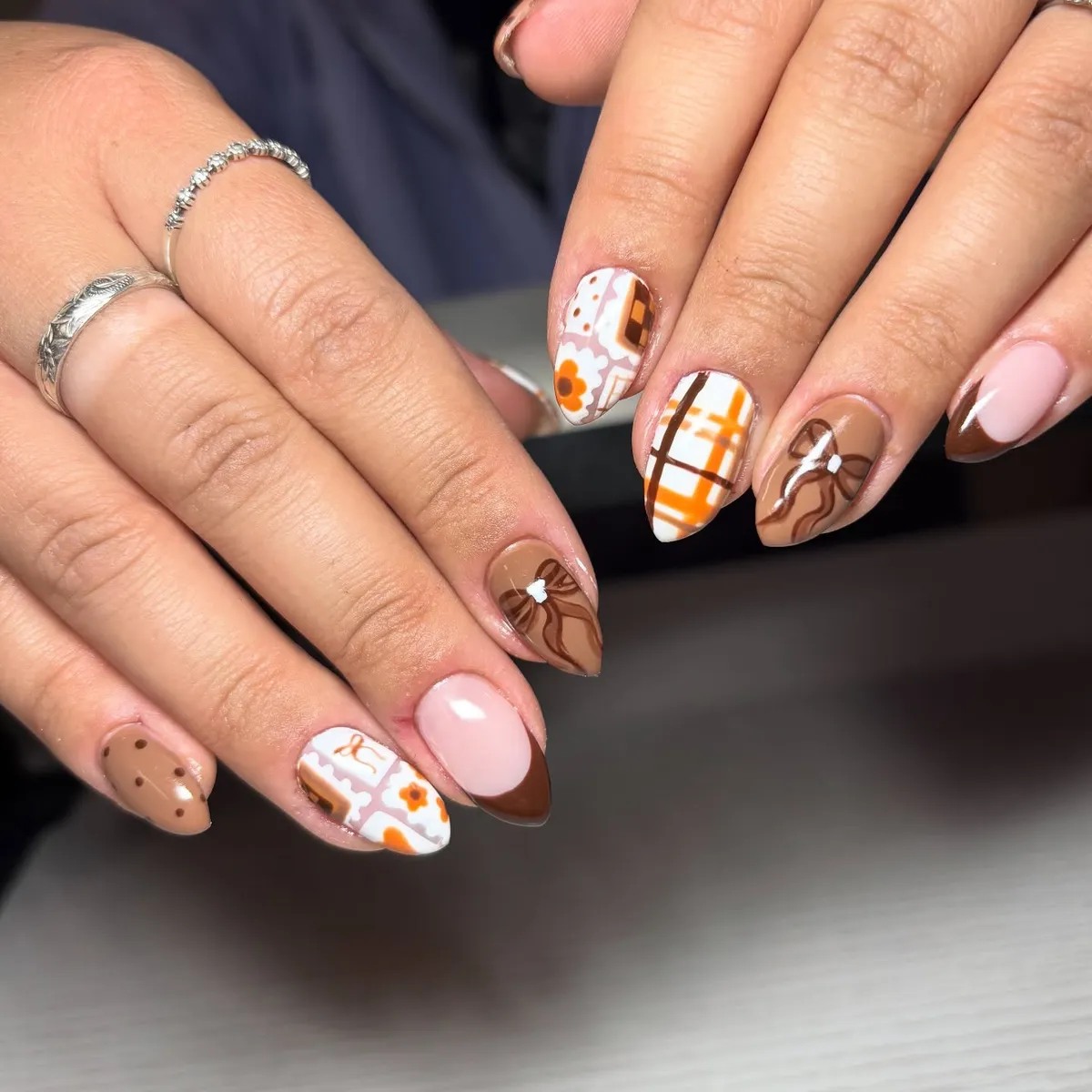 Brown French tips with bows, plaid, and patchwork accents