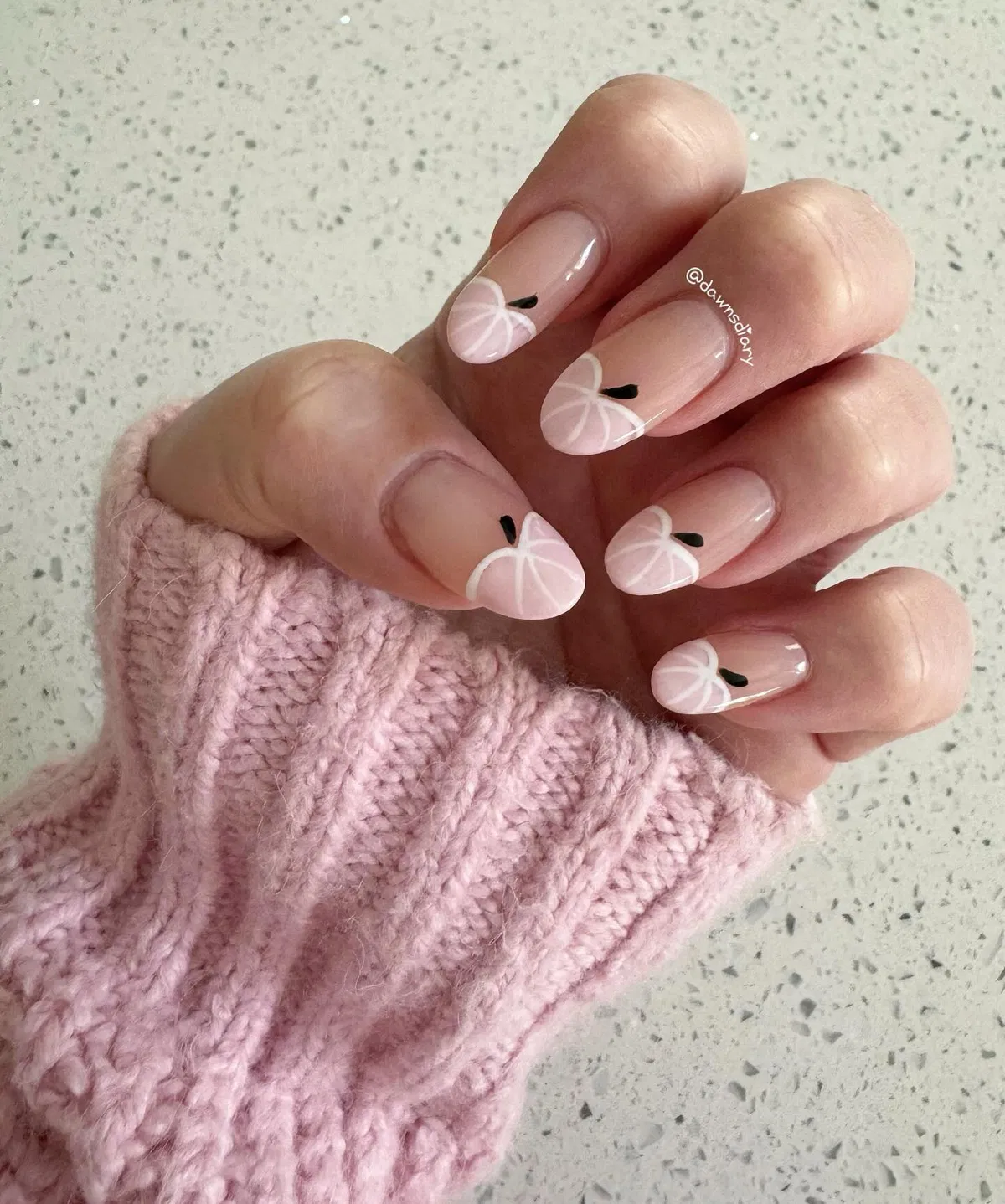 Minimal pumpkin outlines on nude-pink nails