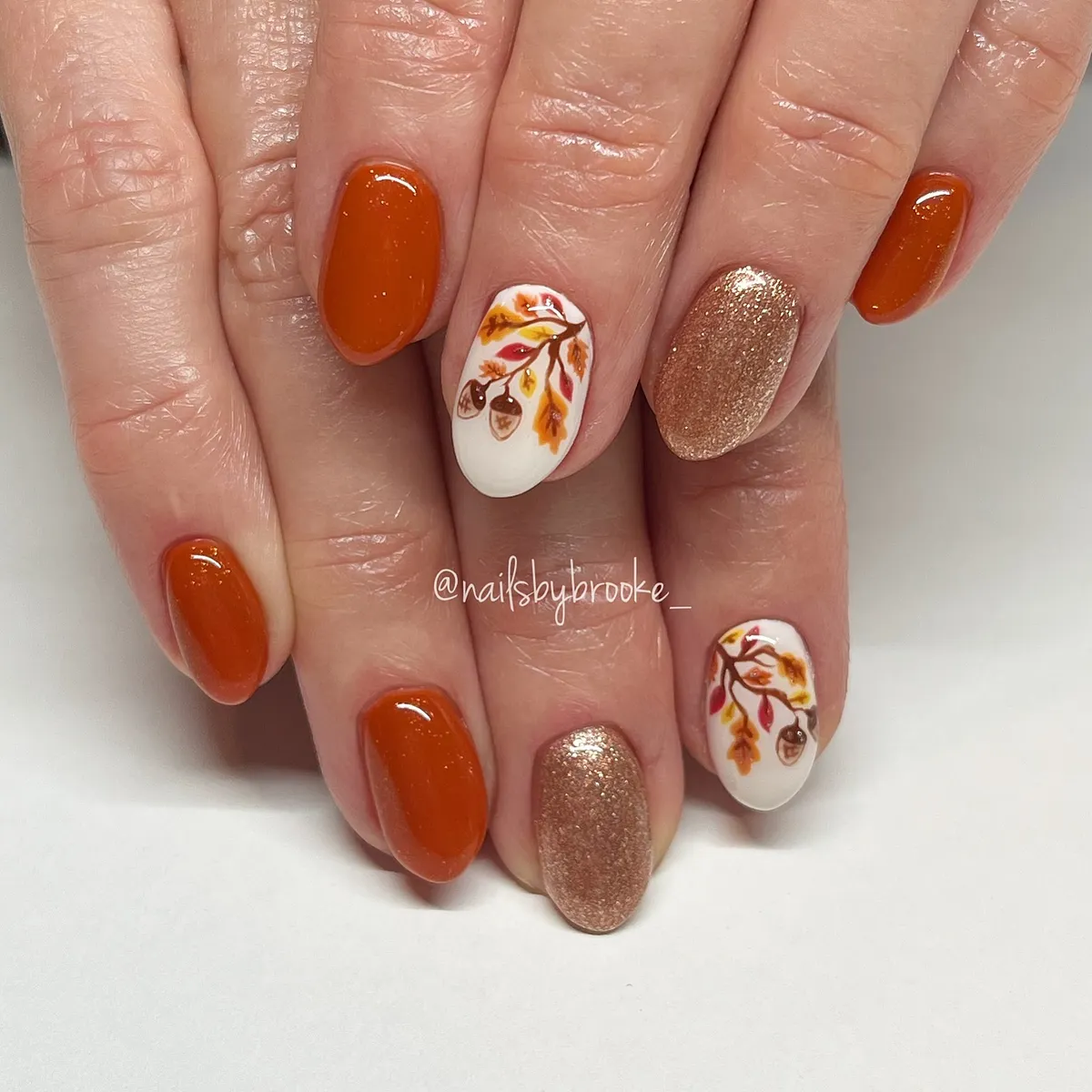 Burnt orange with leaf-and-branch white accents