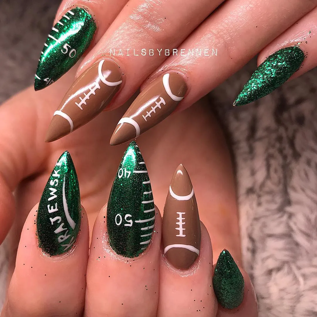 Green glitter field markings with stiletto football nails