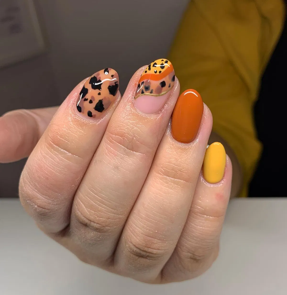 Orange and yellow solids with spotted accent nails
