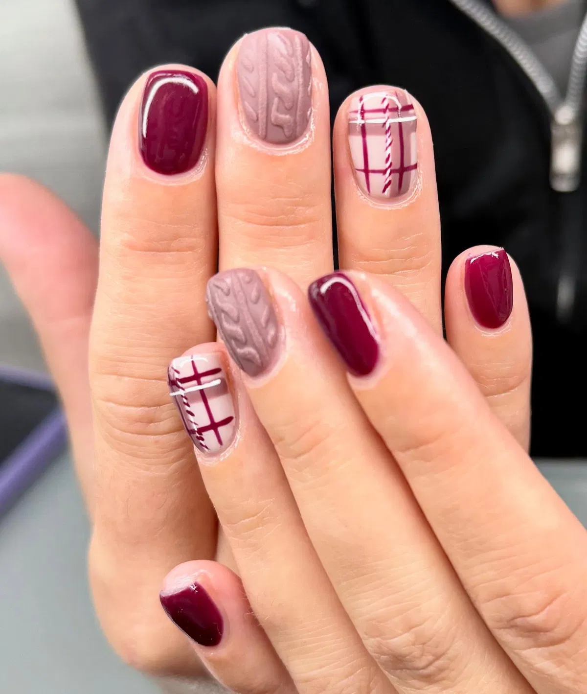Burgundy gloss with cable-knit texture and plaid accents