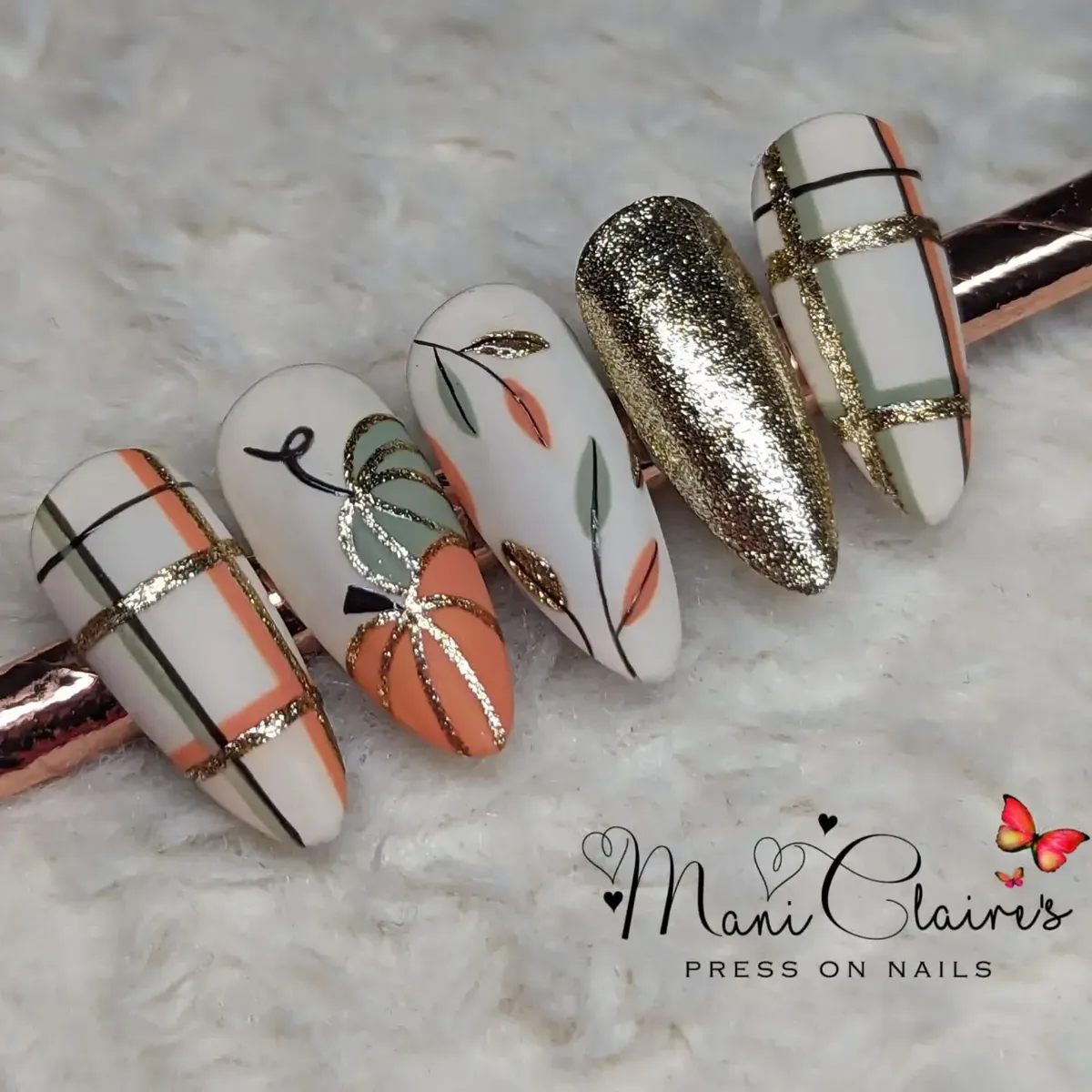 Plaid striping, pumpkin motif, and full-glitter gold nail