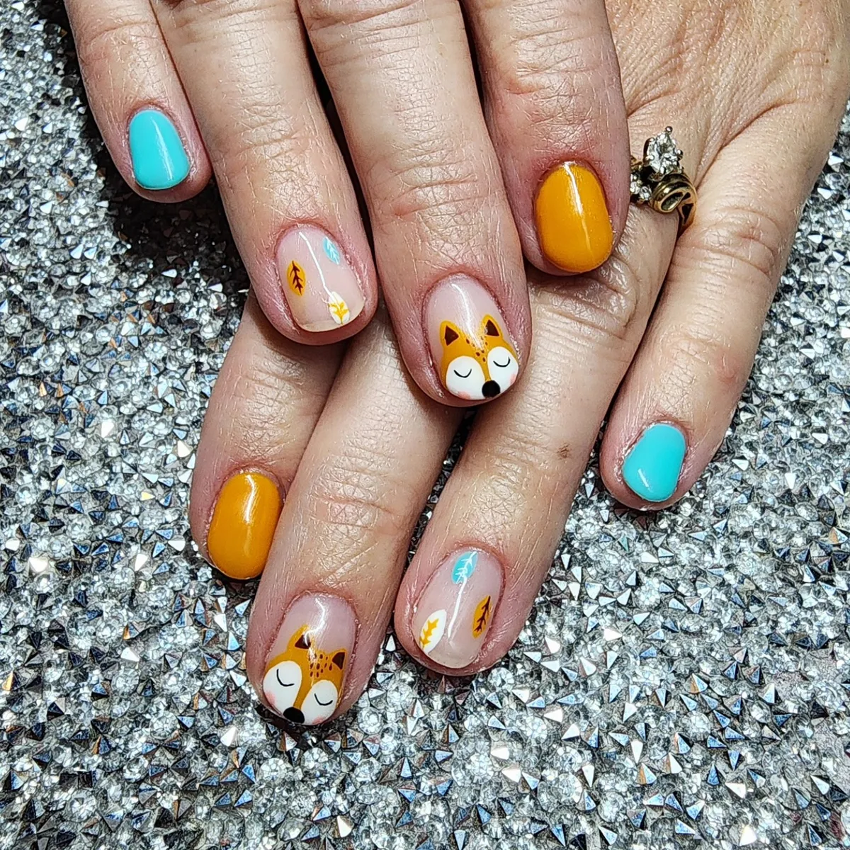 Turquoise and mustard with small leaf motifs and fox-face accents