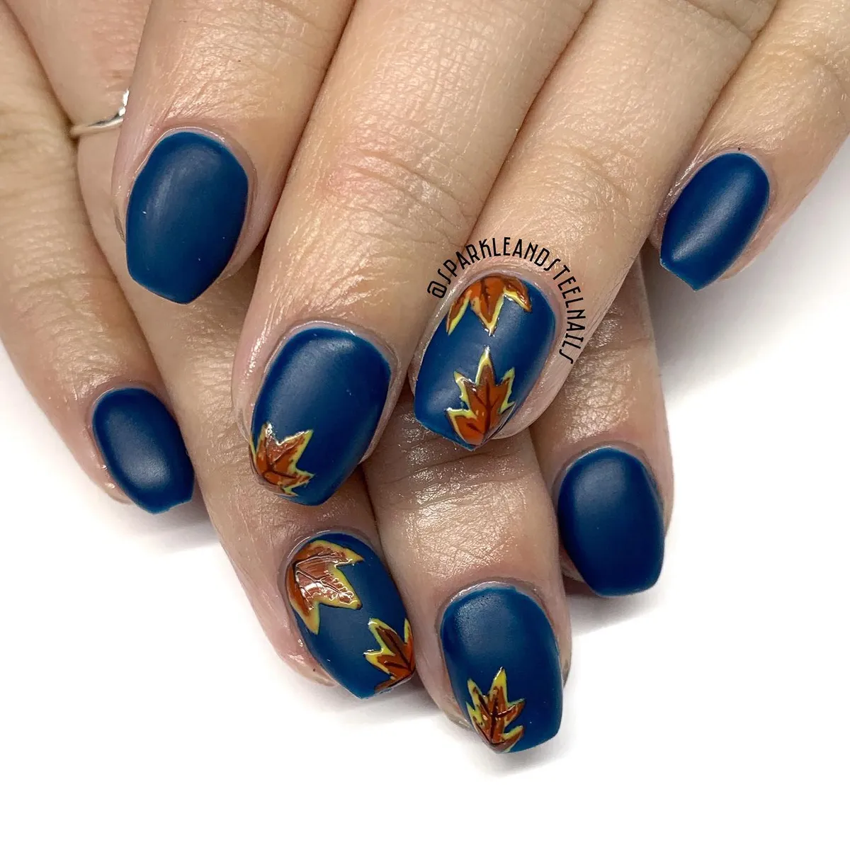 Matte dark blue with orange leaf accents