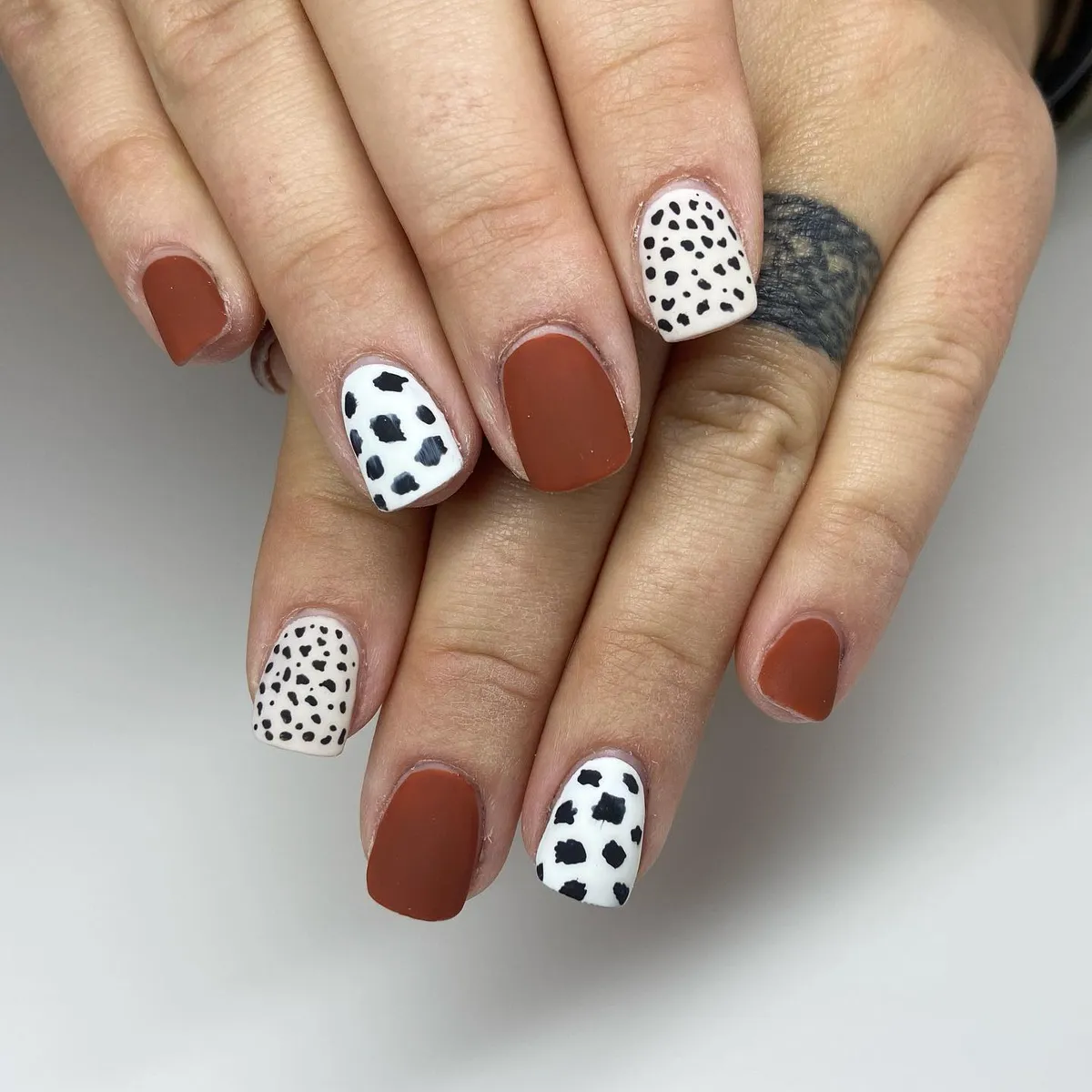 Matte rust-brown with spotted accent nails