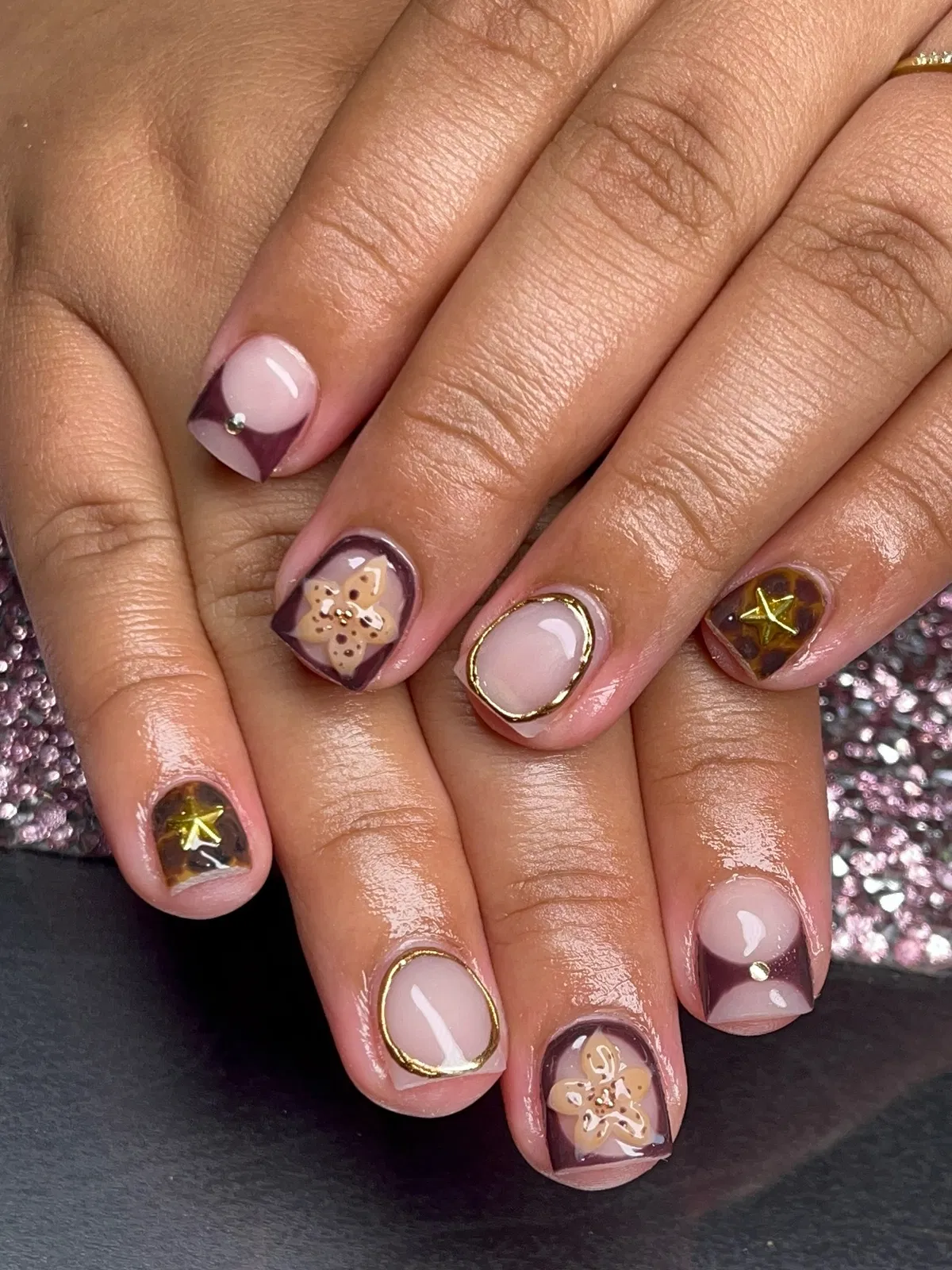 Geometric purple tips with gold outlines and star accents
