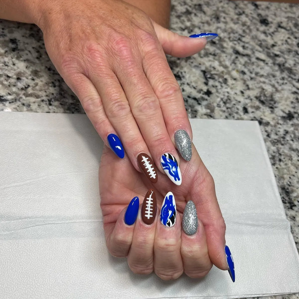 Blue and brown football-lace accents with silver glitter nails