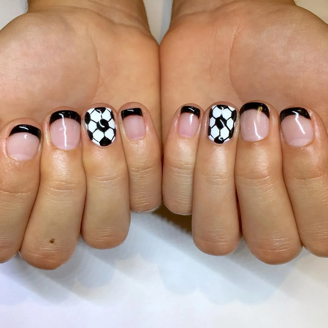 Black French tips with soccer ball accent nails