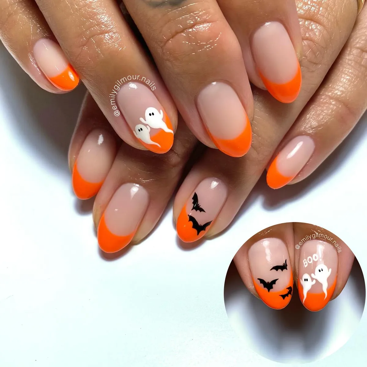 Orange French tips with tiny ghost and bat accents