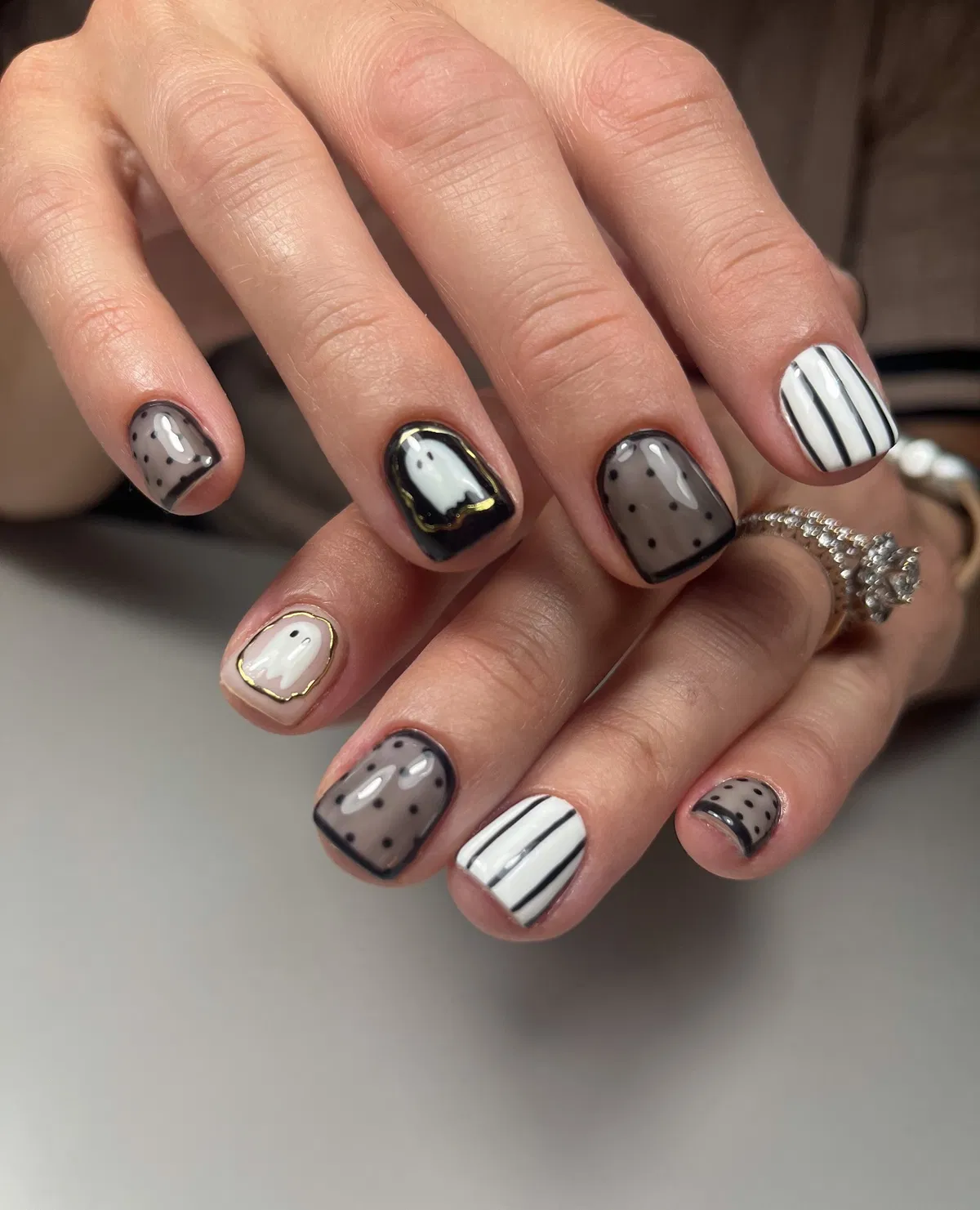 Monochrome mix with polka dots, stripes, and gold-outlined ghosts