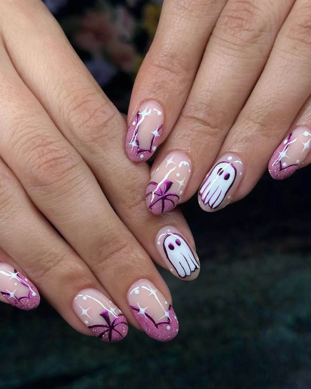 Nude base with pink glitter tips and outlined ghosts
