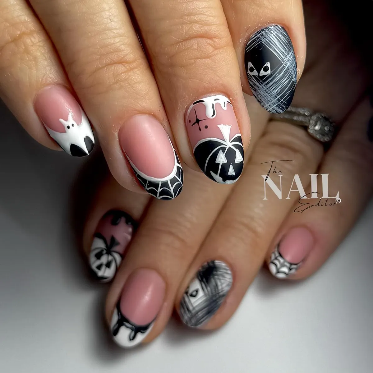 Pale pink base with webs, ghost accent, and graphic black details