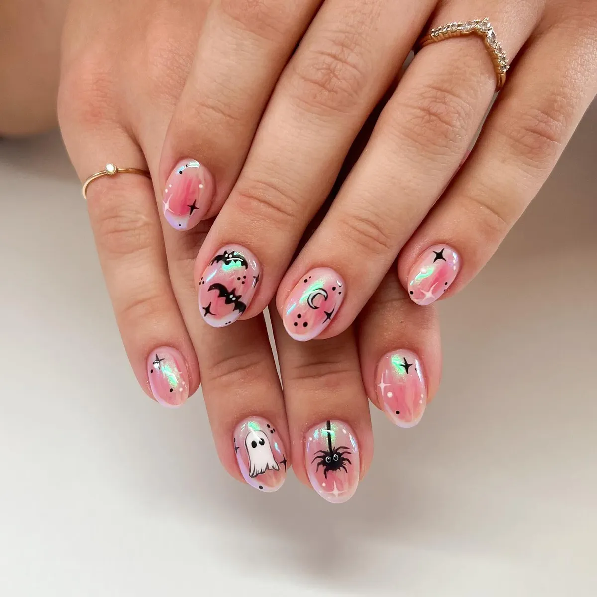 Pink iridescent sheen with bat, moon, ghost, and spider