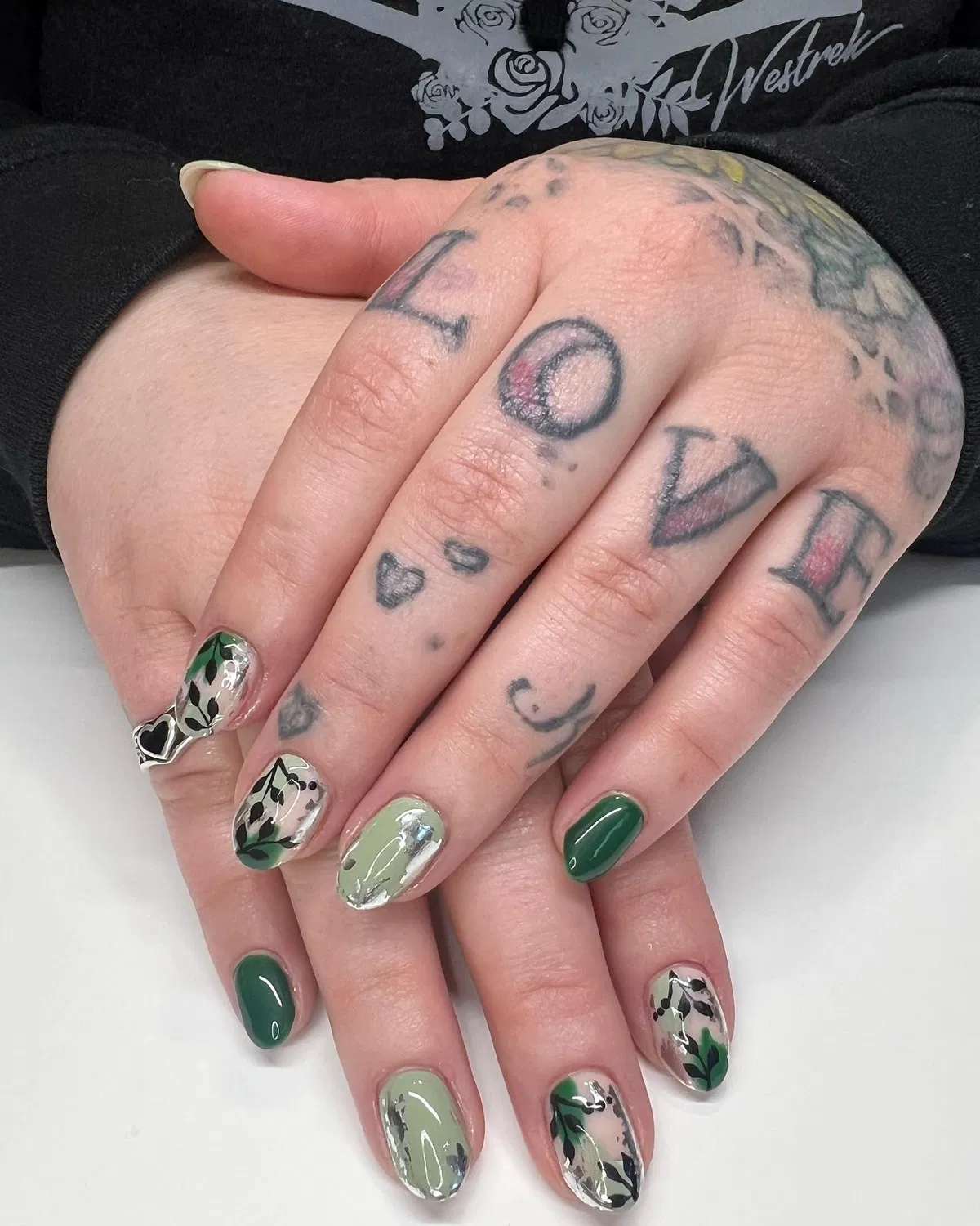 Glossy greens with botanical overlays and silver patches