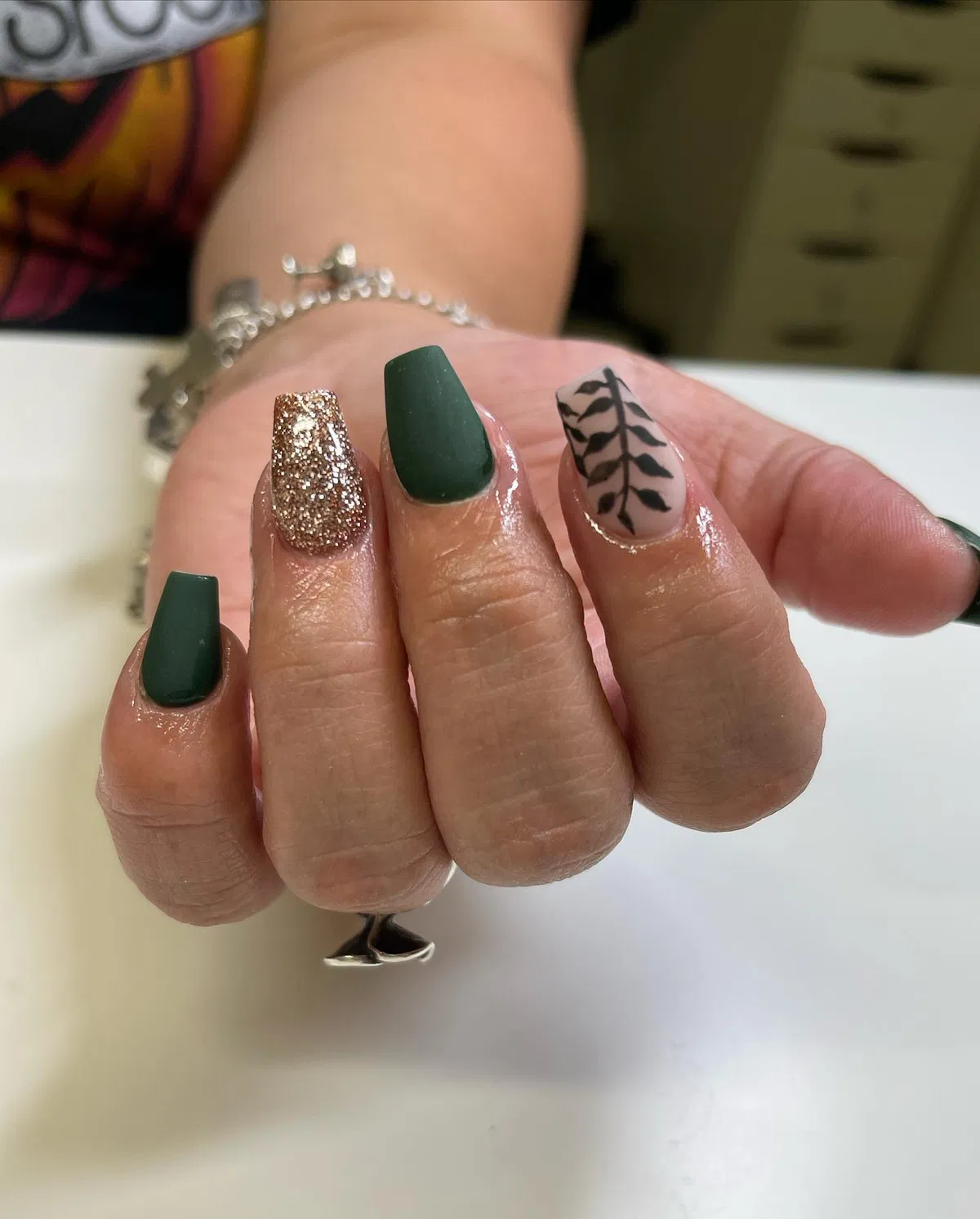 Matte dark green with gold glitter and leaf silhouette
