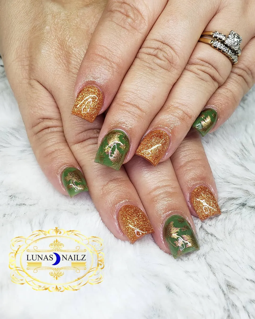 Copper glitter and green nails with gold foil-style accents