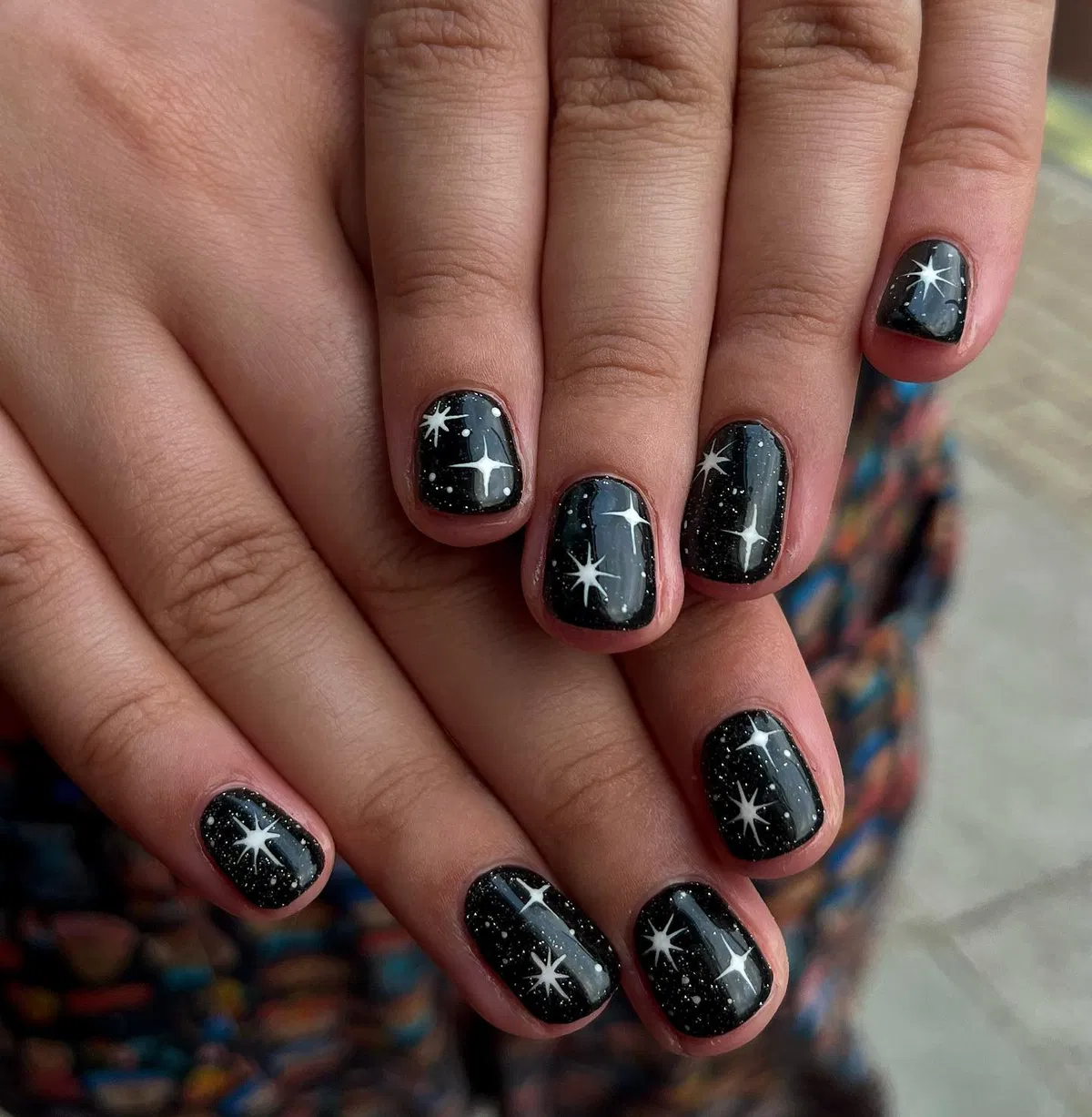 Black speckled nails with white starbursts