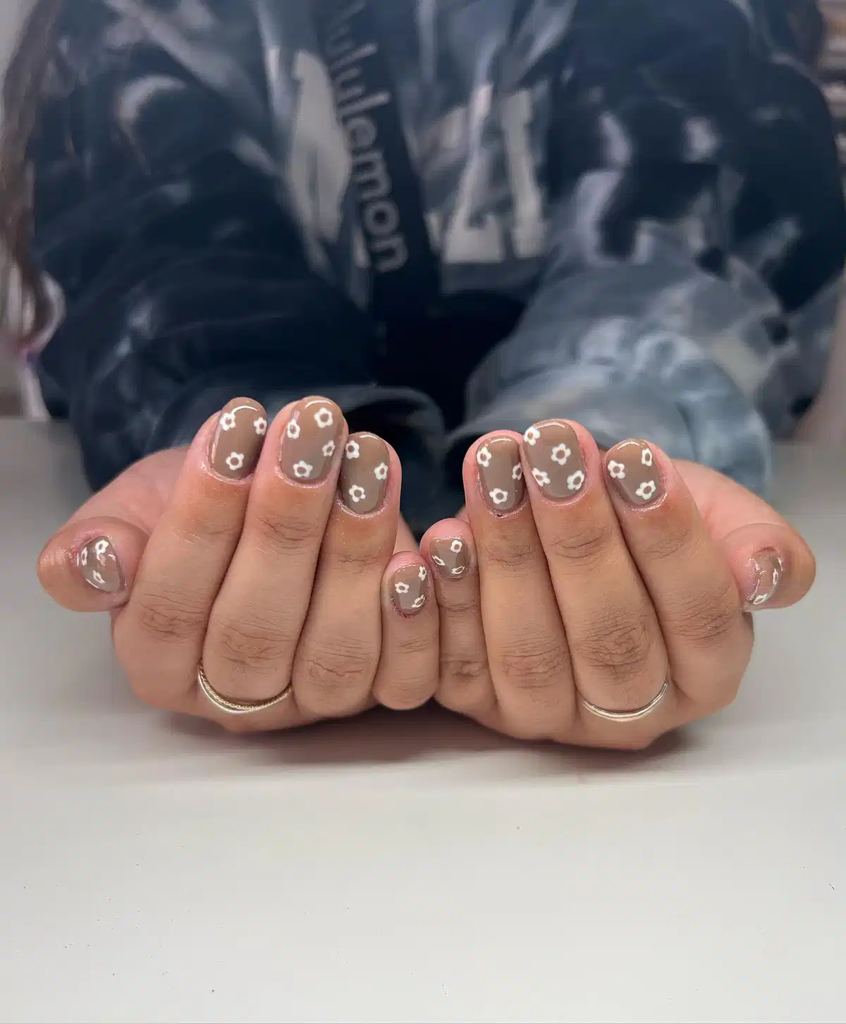 Taupe Nails with Small White Flower Motifs