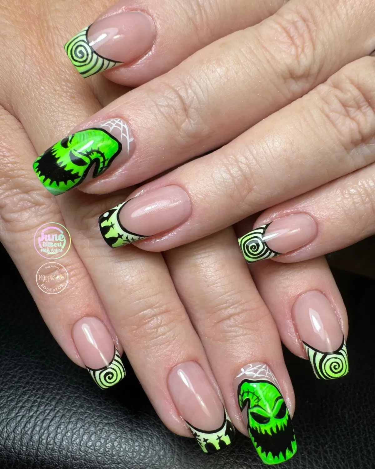 Neon green and black French tips with spirals and face accents
