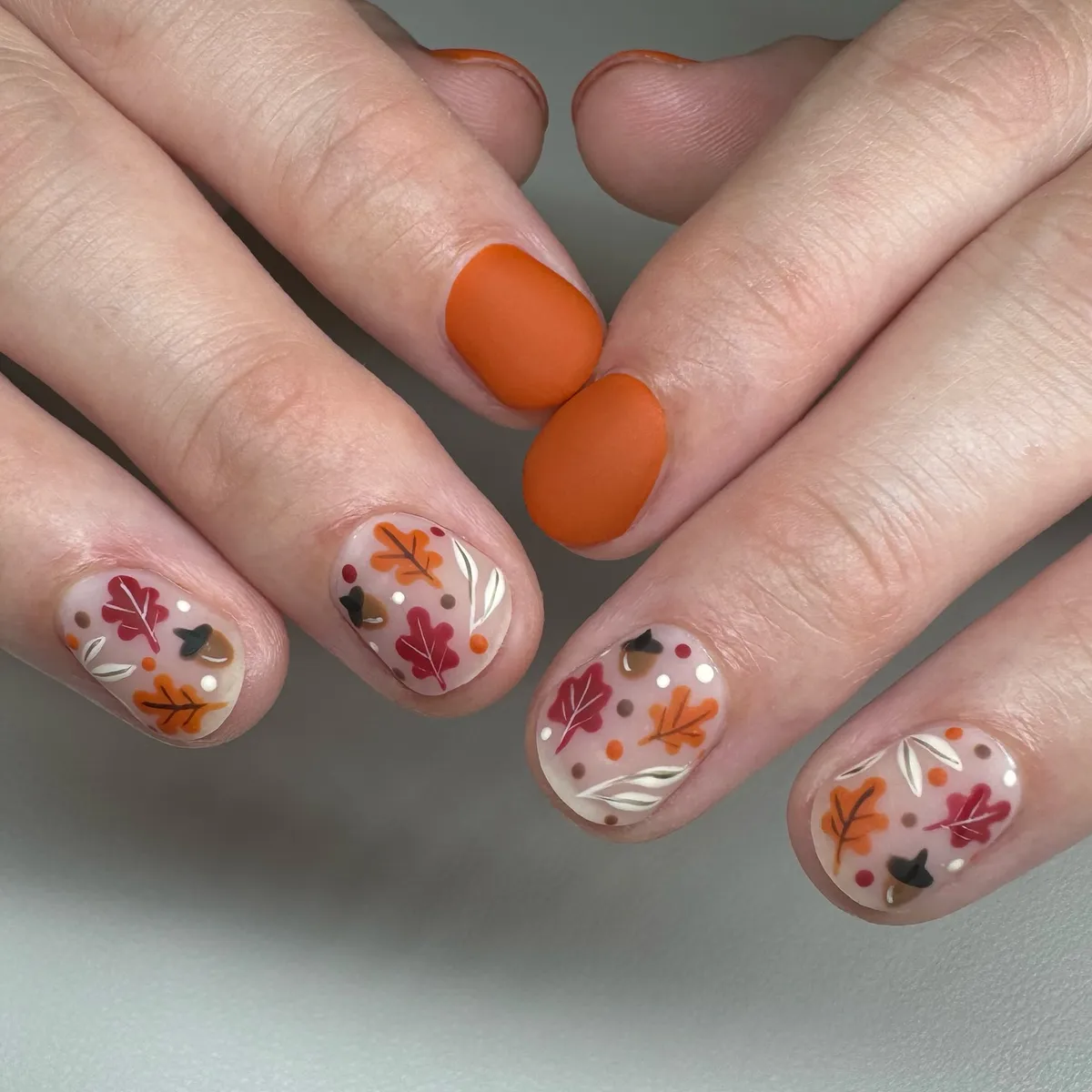 Matte orange with clear-base leaf-and-dot confetti art