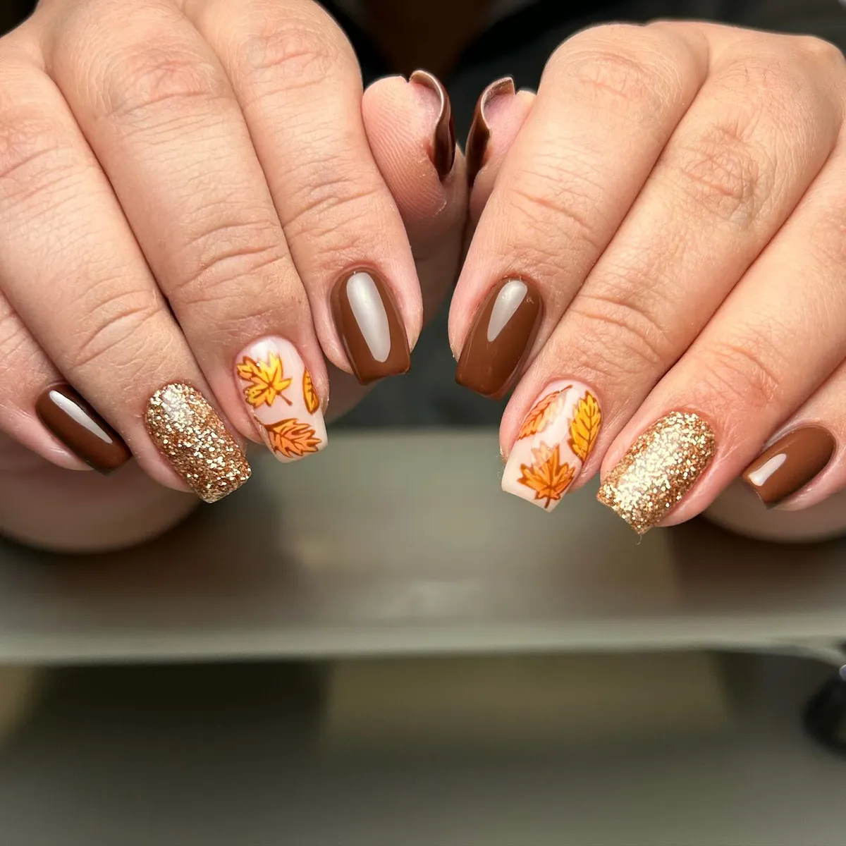 Glossy brown with gold glitter and orange leaf accents