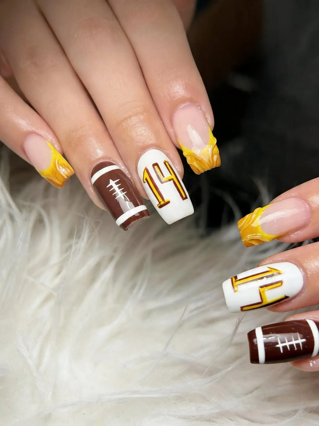 Long nails with sculpted yellow tips and "14" number art