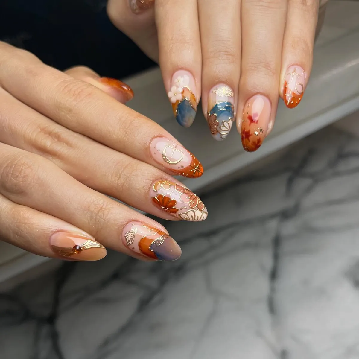 Gold-outlined florals with orange and blue-gray accents