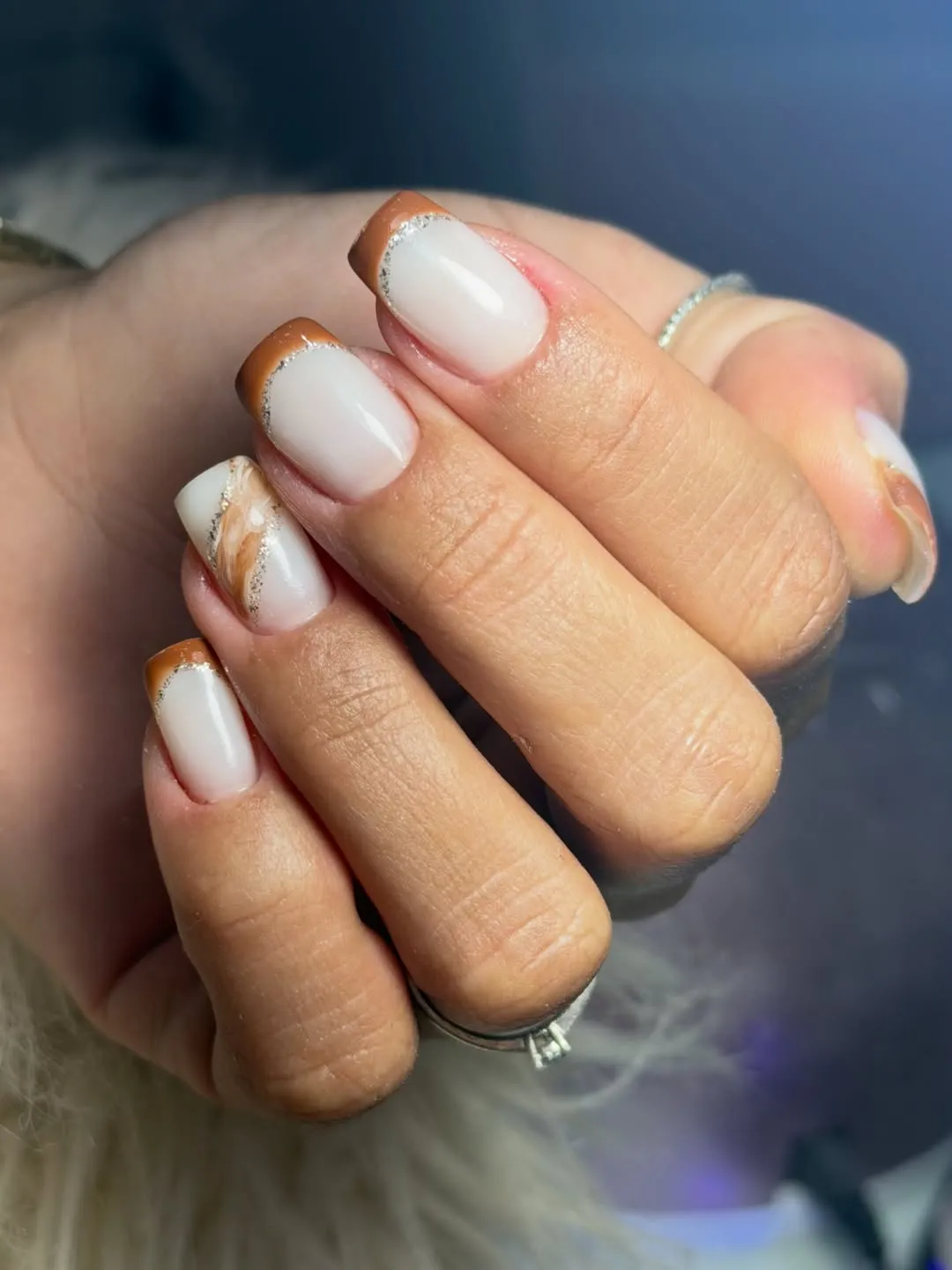 Milky white with brown French tips and silver glitter line