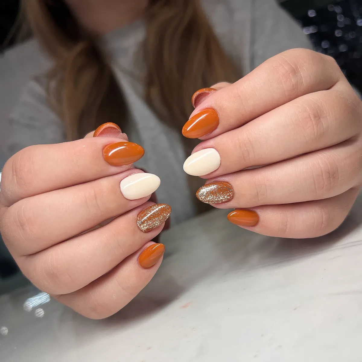 Orange-brown and cream with a gold glitter accent nail