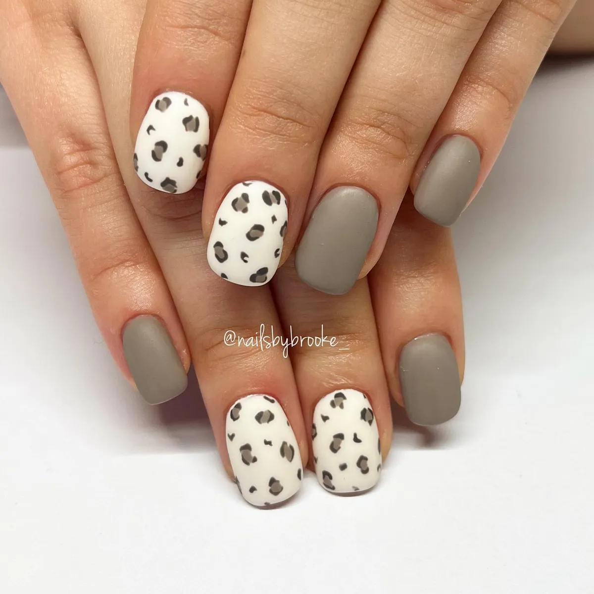 Matte taupe-gray with white leopard spots